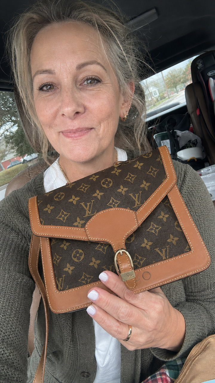 A woman holding a vintage Louis Vuitton bag